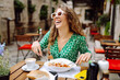 © maxbelchenko - Woman eating italian pasta and drinking coffee at restaurant on the street in Rome. Concept of Italian gastronomy and travel.