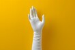 © Valentin - A Gloved Hand Against a Bright Yellow Background