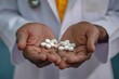 © Vii - A doctor holding a handful of pills in his hands, ready for use