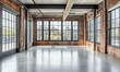 © Александр Михайлюк - The spacious interior features large windows allowing natural light, highlighting the exposed brick walls and smooth concrete flooring in a modern industrial setting