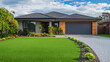 © CreativeCreations - A contemporary Australian home or residential buildings front yard features artificial grass lawn turf with timber edging