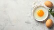 © MagiCraft - Raw egg in bowl with two whole eggs and herbs on white background