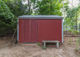 red wooden shed with double doors