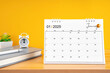 © gamjai - January desk calendar for 2025 year on work table with yellow.