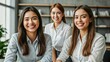 © Januka - Confident professional women smiling warmly in a modern office setting, dressed in business attire, exuding positivity and professionalism.