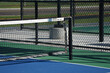 © Tedi S Photography - closeup of an empty outdoor blue and green pickleball court with net