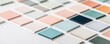© ImagePulse - Close-up of a variety of paint color samples spread on a whiteboard, natural shadows, photorealistic office environment