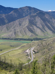 Wall Mural - View on winding mountain road Chuya Highway on slopes mountain pass Chike-Taman in Altai.