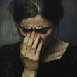 © Mary Salen - A devastated crying woman closeup covering her face with her hand with dark grunge background depression loss grief mental illness rage anger sadness concepts