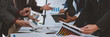 © Phimwilai - A team of business people discuss, brainstorm, present reports on the board, make calculations, meeting with colleagues in the office. Project analysis report Investment results and company profits.