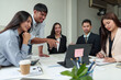© Phimwilai - Financial analyst analyzes business finance reports on laptop and graph documents during corporate meeting discussions showing successful teamwork, business meeting ideas, marketing.