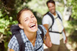 © peopleimages.com - Happy woman, portrait or couple in woods for hiking, adventure or travel journey on break in nature. Laugh, smile or face of people in Italy holding hands for holiday trip or trekking to explore park