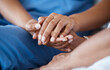 © peopleimages.com - Nurse, patient and holding hands for support, healthcare and empathy with love, care and trust. People, consultation and caregiver with kindness, compassion and therapy for mental health or wellness