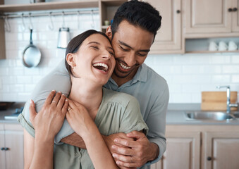 couple, laughing and embrace in kitchen together for intimate moment, funny joke and connection in h