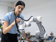 © Nassorn - Hispanic engineer woman working on AI technology in robotics electronics engineering laboratory. University students' research project is programming robot machine with intelligent mechanical control