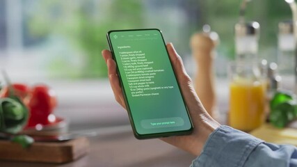Fototapete - Hand Holds a Smartphone Displaying an AI Chatbot Interface. Device Shows Recipe Ingredients and Instructions, Ai Assistant Provides Culinary Guidance. Technology Helps  Mobile Phone User