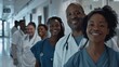 © VK Studio - A diverse group of medical staff stands smiling in a hospital corridor, showing camaraderie and trust in their important teamwork.