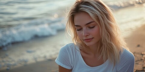 Poster - Blonde woman wearing a white t-shirt at the beach