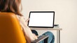 © Chalermrach - A mockup tablet image featuring a person using a tablet while sitting in a chair, with a clipping path on the screen for easy design replacement, relax, stock photo
