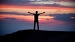 © yogiandrias - Silhouette of a Man with Arms Outstretched Against a Dramatic Sunset Sky