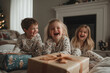 © gankevstock - Children enjoying Christmas morning while unwrapping presents together