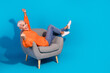 © deagreez - Photo of excited old lady sit chair raise fists up winning wear season knitted clothes isolated blue color background