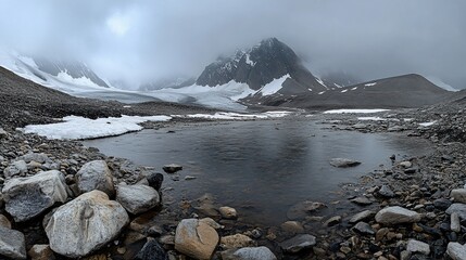 Wall Mural - a tranquil mountain lake with snow-capped peaks in the background.
