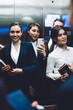 © BullRun - Content coworkers taking selfie while standing in elevator together