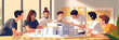 © Lila Patel - A team of young architects huddled around a scale model of a building, using various tools to manipulate and revise their design, showcasing their adaptability and problem-solving skills.