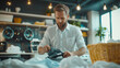 © DOUGLAS - man ironing shirt in tidy laundry room with basket of clothes nearby, creating focused and organized atmosphere