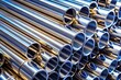 © chaowalit - Shiny Steel Pipes Stacked Close-Up