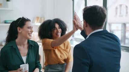 Canvas Print - Video of business team celebrating good job while holding up their right hands on modern startup