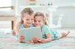 © peopleimages.com - Girls, tablet and children in home for bonding, development and playing games with app or internet. Siblings, learning and watch cartoon for happy family, streaming video and social media on weekend