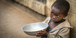 © Hawkeye.Creatix - A hungry child holding an empty bowl, highlighting the issue of food insecurity and the need for support and assistance.