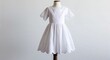 © Things and stuff - White cotton eyelet dress with flared skirt and scalloped edges display on plain white background