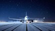 © realone952 - On a winter night in the snow, a passenger plane prepares to take off at the airport