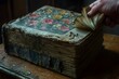 © AgungRikhi - An aged book with floral cover and worn pages, being gently flipped open.