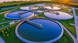 © Cheewynn - Aerial sunset view of sewage treatment plant, circular tanks with reflective surfaces