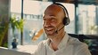 © LukaszDesign - Business consultant providing support and advice in an office setting, featuring a cheerful employee with a headset engaged in communication for customer assistance