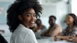 © LukaszDesign - Joyful woman in a leadership role participating in a teamwork meeting, promoting diversity and collaboration. Portrait of a motivated individual focused on achieving goals