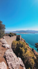 Wall Mural - Breathtaking panoramic view of the Strait of Gibraltar from the Royal Walls, showcasing Ceuta and the Moroccan coastline under clear blue skies