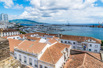 Wall Mural - A view over the rooftops towards the marina and harbor in Ponta Delgada on the island of Sao Miguel in the Azores in summertime