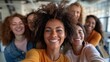 © LukaszDesign - Joyful group of young friends capturing a selfie together with a smartphone. Team of professional women posing for a picture with a mobile device in a workplace setting