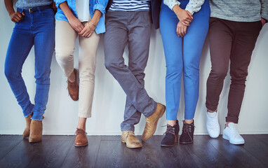 Poster - Design agency, legs and waiting with business people in line at office for hiring, interview or recruitment. Studio, wall and wooden floor with creative employee group in row for job opportunity