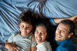 © peopleimages.com - Parents, boy and happy on portrait in bed for playing, fun and bonding for memories. People, family and above on smile with kid for support, love and care at home for child growth and development