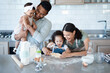 © peopleimages.com - Happy family, kids and baking with cookie cutter to shape dough, flour and carrying baby in kitchen. Mom, dad and children cooking with parents, help and teaching dessert recipe for support in home © peopleimages.com - Happy family, kids and baking with cookie cutter to shape dough, flour and carrying baby in kitchen. Mom, dad and children cooking with parents, help and teaching dessert recipe for support in home