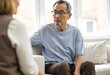 © StockLab - Middle aged man wearing a blue shirt sitting on sofa and thinking during conversation