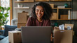 © EmmaStock - Happy business owner managing a successful online store from their home office, smiling as they pack orders for shipment