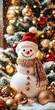 © petro - Snowman wearing santa hat and scarf holding christmas ornament