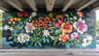 © Asad - A vibrant floral mural on a pedestrian bridge, depicting a beautiful array of flowers in full bloom, transforming the structure into a stunning work of public art that brightens the urban landscape.